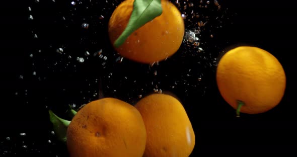 Whole Mandarins Falling Under Water with Air Bubbles.  alt