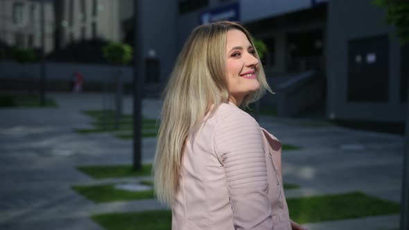 Young Woman Walking on the Street Near Business Center alt
