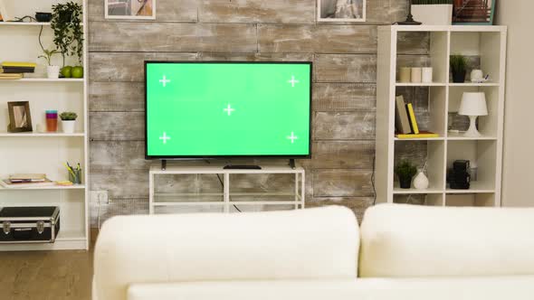 Big Green Screen TV in a Bright and Well Lit Living Room with Nobody in It alt