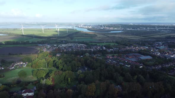 Cheshire farmland countryside wind farm turbines generating renewable green energy aerial view movin alt
