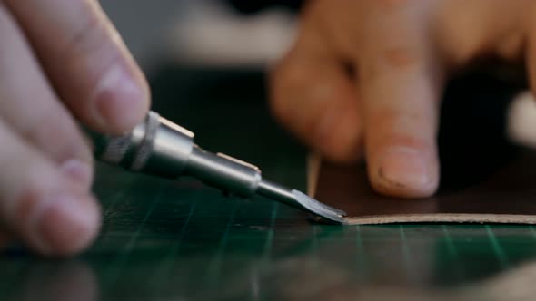 The Master Cuts the Edge of the Skin. A Person Performs One-handed Action. Side View Is Macro. The