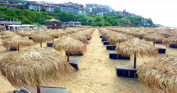 Drone Camera Rising Over Reed Umbrellas on the Bulgarian Beach