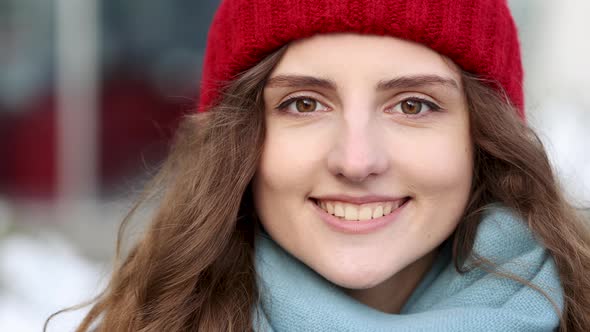 Portrait of Attractive Urban Young Woman in Stylish Winter Outfit and Red Hat Smiling to Camera