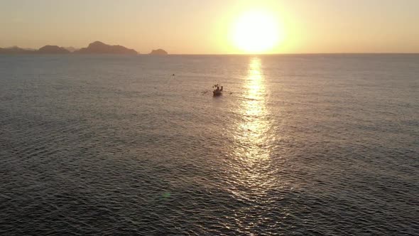 Aerial view of outrigger Boat during sunset in El Nido alt