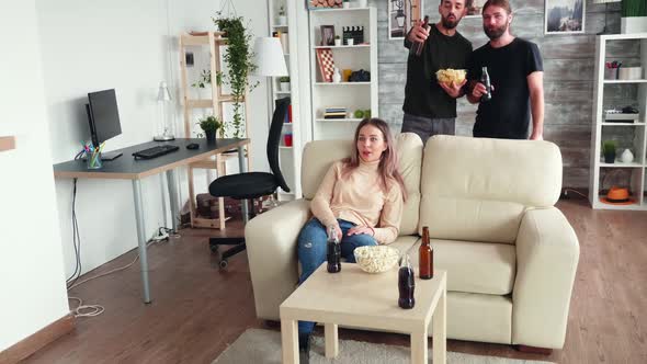 Old Friends Relaxing Together Watching Tv and Drinking Beer alt