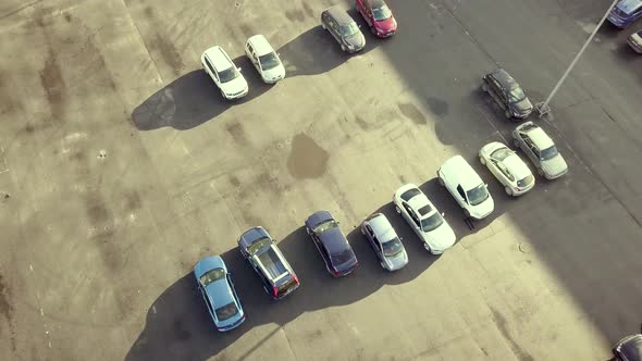 Top aerial view of many cars on a parking lot of supermarket or on sale car dealer market. alt