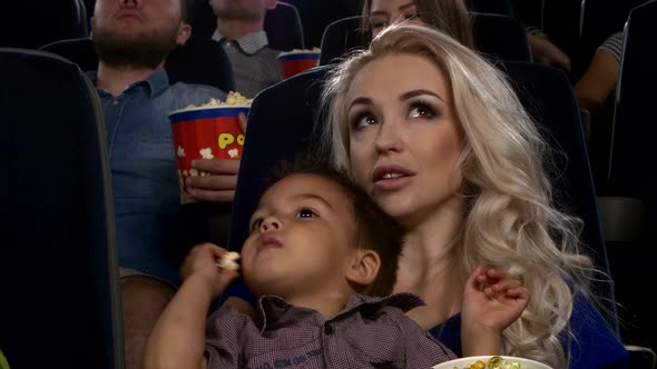 Mother Watching Film In Cinema With Children, Close Up alt