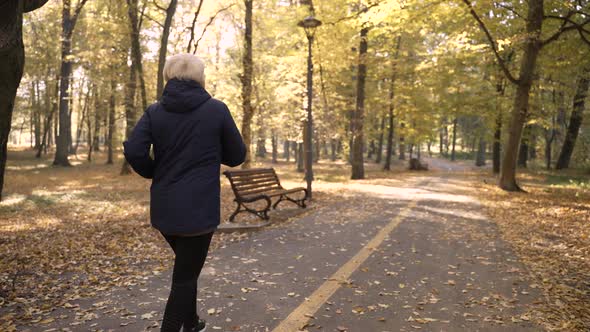 Healthy Elderly Female Enjoying Jogging Outdoors alt