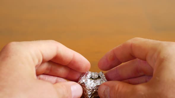 Male Hands Unpack the Pressed Marijuana alt