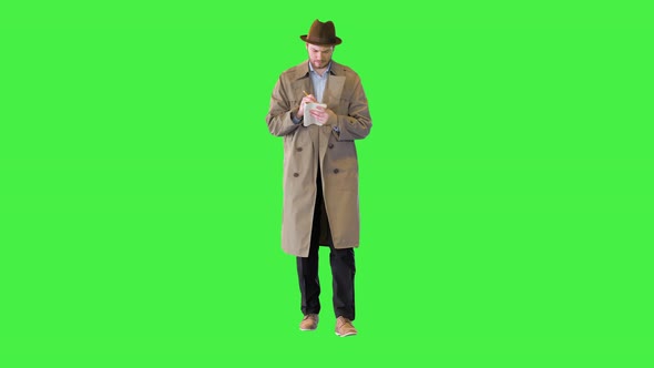 Confident Private Detective Police Agent with Notebook Walking Dressed in Beige Coat and Hat Noting