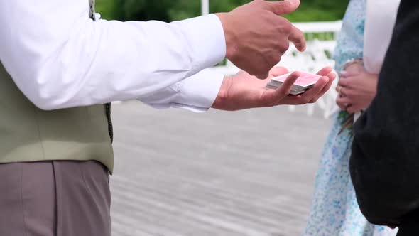 Magician Offers to Choose a Playing Card Closeup