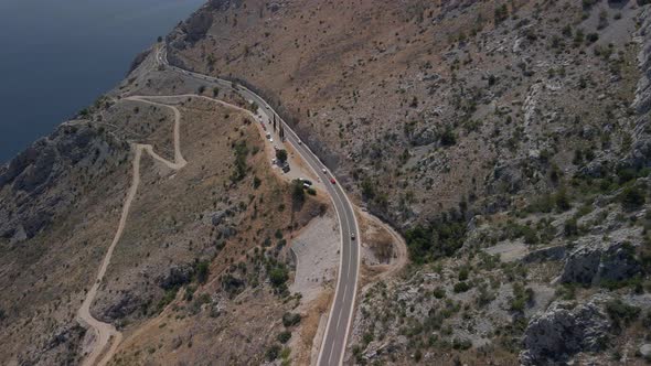 Fantastic Aerial View of a Mountain Road with Incredibly Beautiful Sea in the Background