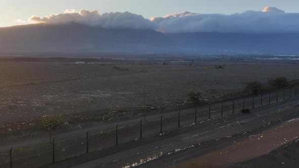 Aerial View of Landfill with Plastic Bags at Sunset Mountains Covered By Clouds alt