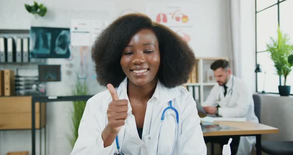 African American Female Doctor in Medical Uniform with Stethoscope Posing on Camera alt