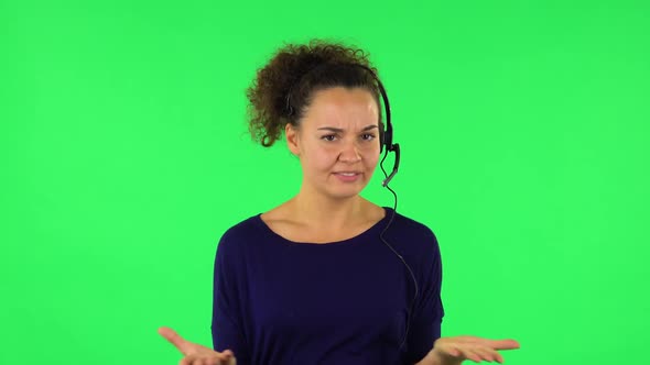 Portrait of Curly Woman Talking on Headphones, Call Center. Green Screen alt