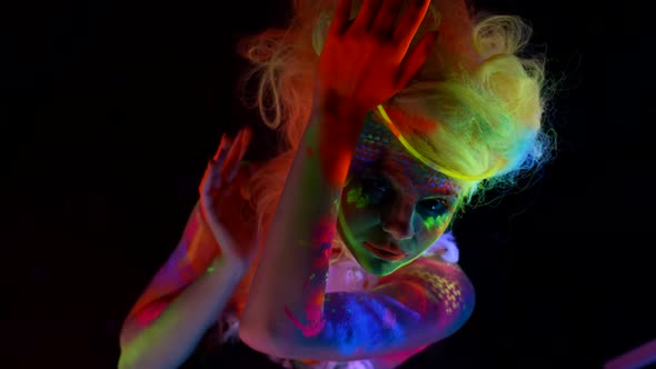Strange Woman with Fluorescent Makeup on Face and Body Extravagant Hairstyle for Actress alt