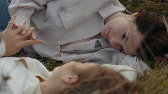 Happy Lesbian Couple Resting Together Outdoors alt