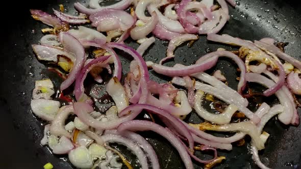 Preparation Chopped Fried Onion in Frying Pan in Domestic Kitchen for Cooking Food on Kitchen Stove alt