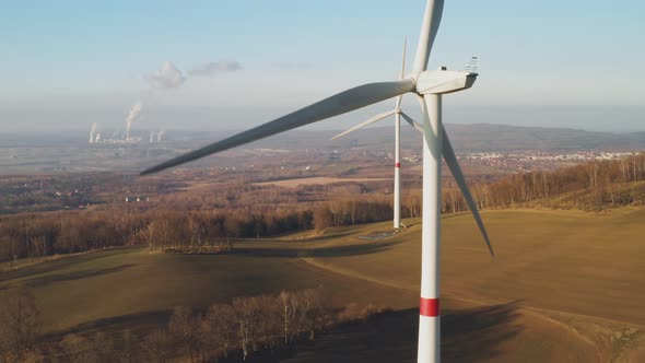 Wind Turbine Generate Electricity on the Background of Nuclear Power Station alt