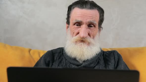 Elderly Man Gets Frustrated with Laptop alt