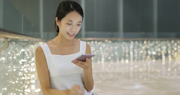 Woman Use of Mobile Phone in The Shopping Mall alt