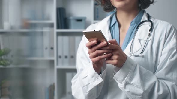 Woman Doctor Works Using Mobile At Consultation. Online Consultation. Unrecognizable Doctor alt