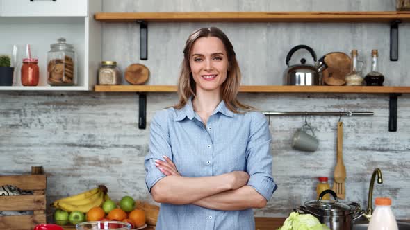 Modern Housewife Posing at Kitchen Surrounded By Food and Dishes alt