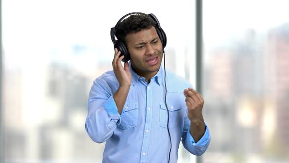 Cheerful Man Listening To Music with Headphones. alt