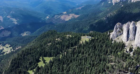 Piatra Singuratica Rock Formation Amidst The Green Woods At The Hasmas Mountains alt
