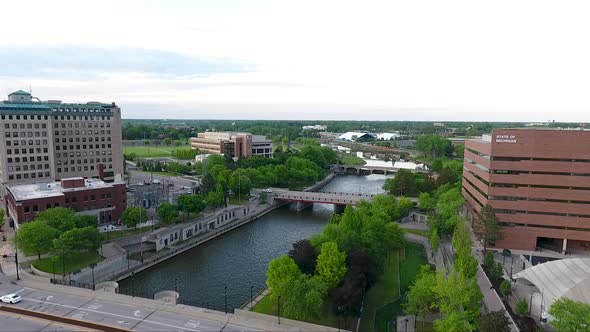 A drone shot captures footage flying north over Saginaw Street and the Flint River in Flint, Michiga alt