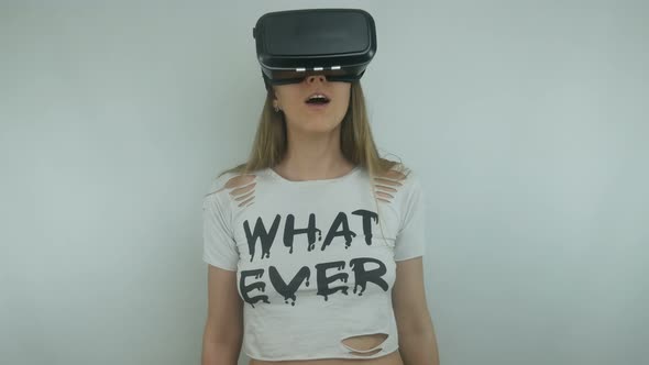 Beautiful Woman Uses A Virtual Reality Helmet And Full Immersion Technology