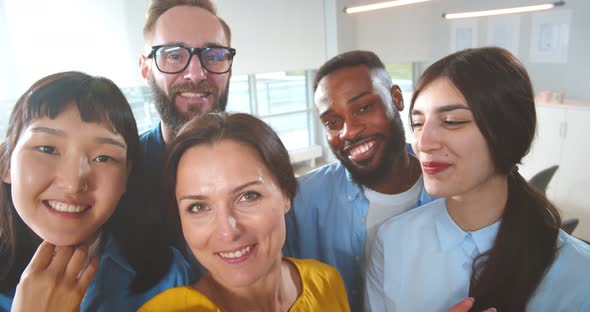 Casual Business Team Taking Selfie on Smartphone Having Break in Office alt