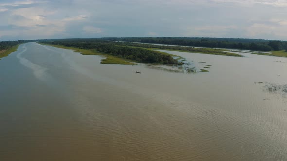 Reveal shot wooden boat in amazon river - Drone shot in Amazonia Peru 4K