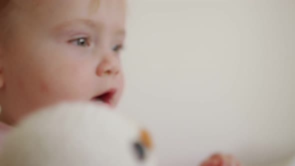 Cute baby playing at home and smiling to the camera alt