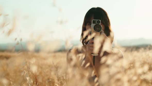 Young Beautiful Girl Makes Video with 8Mm Vintage Camera alt