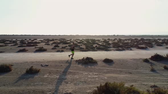 Aerial View From Drone of Runner Jogging in Desert