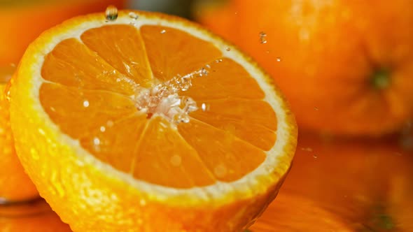 Super Slow Motion Shot of Water Splashing on Fresh Orange at 1000Fps alt