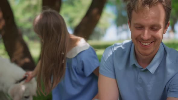 Cheerful Family Rest on Nature Using Tablet Closeup alt