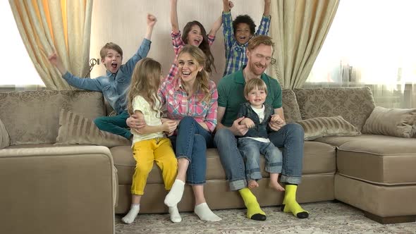 Happy Caucasian Family Watching Tv. alt