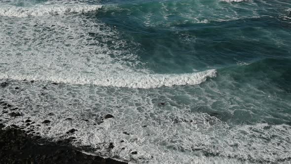 White Foamy Breaking Waves on the Beach with Black Volcanic Sand on Tenerife