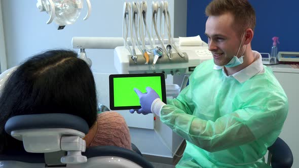 Dentist Points His Hand on Tablet Screen