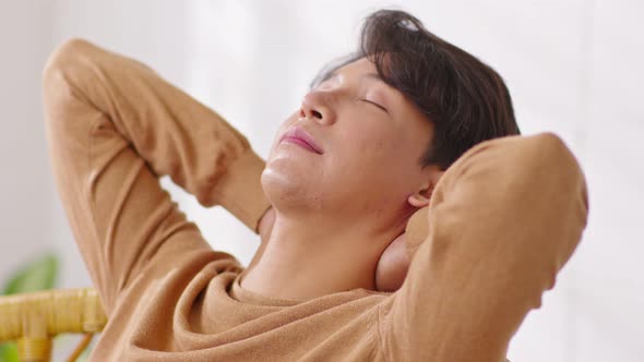 Happiness Asian handsome man lying on sofa close her eyes sleep deep breath relaxation at home alt
