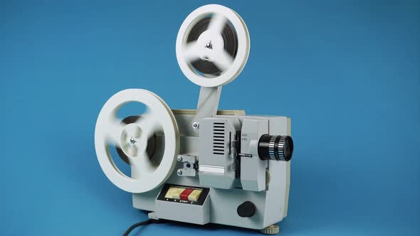 Rewinding Filmstrip On Retro Film Projector. 