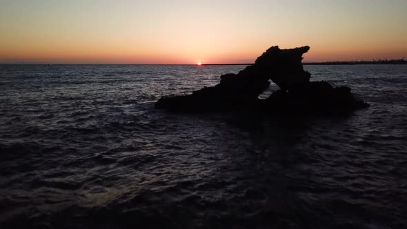 Aerial view of rock formation on the ocean coast of Southern California at sunset alt