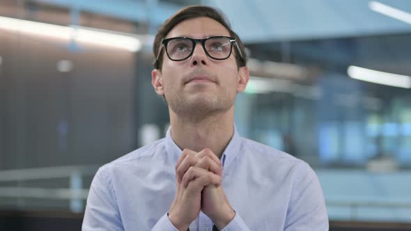 Portrait of Hopeful Young Man Praying alt