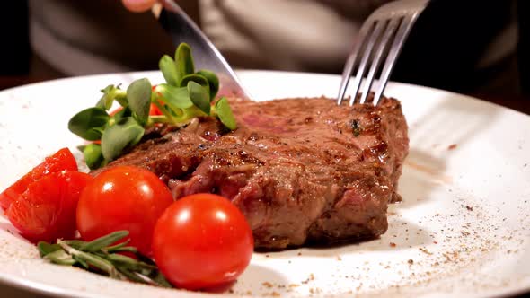 The Cook Cuts and Demonstrates the Freshly Prepared Meat Steak