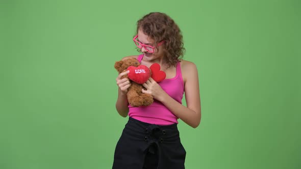 Young Happy Beautiful Nerd Woman Hugging Teddy Bear alt