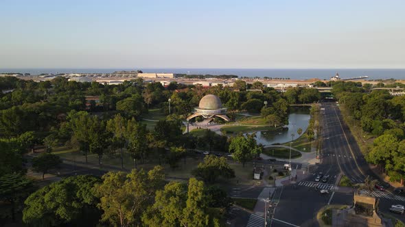 Pan left of Galileo Galilei Planetarium surrounded by Palermo Woods and Rio de la Plata river in bac alt