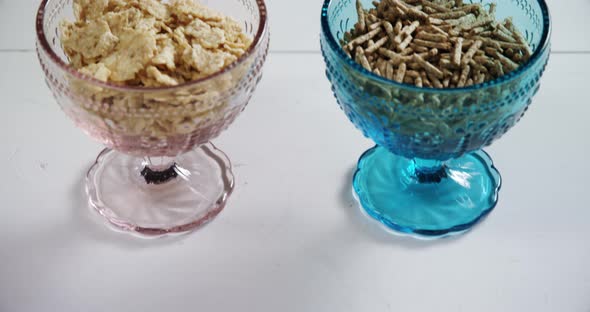 Wheat flakes and cereal bran sticks in bowl 4k alt