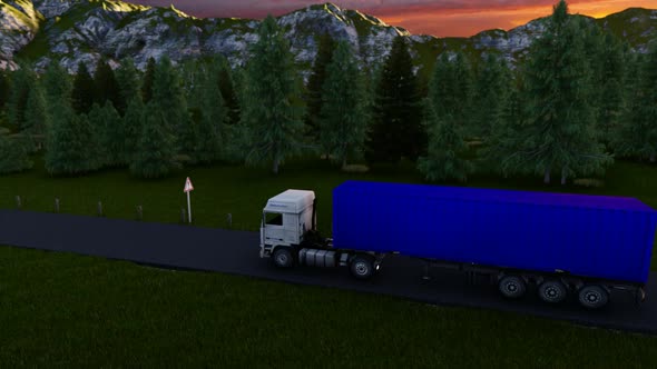 Truck Driving On The Asphalt Road In Rural Landscape At Sunset With Dark Clouds